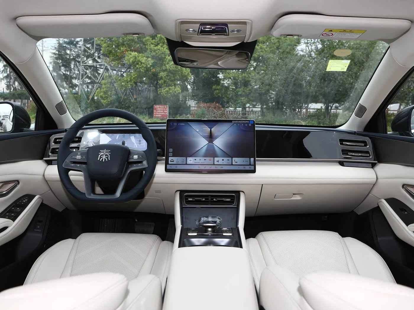 Interior del BYD Qin L con pantalla central y asientos claros